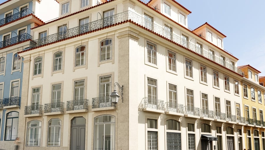 Classic Lisbon apartment building facade under a clear sky