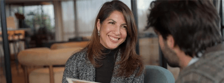 Smiling woman talking with an advisor during a consultation meeting