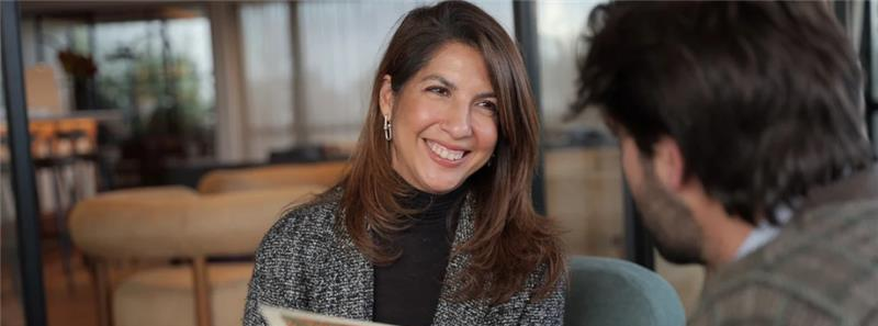 Smiling woman talking with an advisor during a consultation meeting