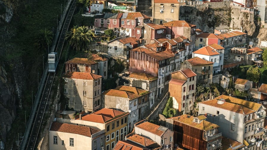 Aerial view of historic houses in Porto, Portugal, with terracotta rooftops and the Guindais funicular nearby. One of the city’s most authentic and picturesque neighborhoods, showcasing Portuguese charm and tradition.