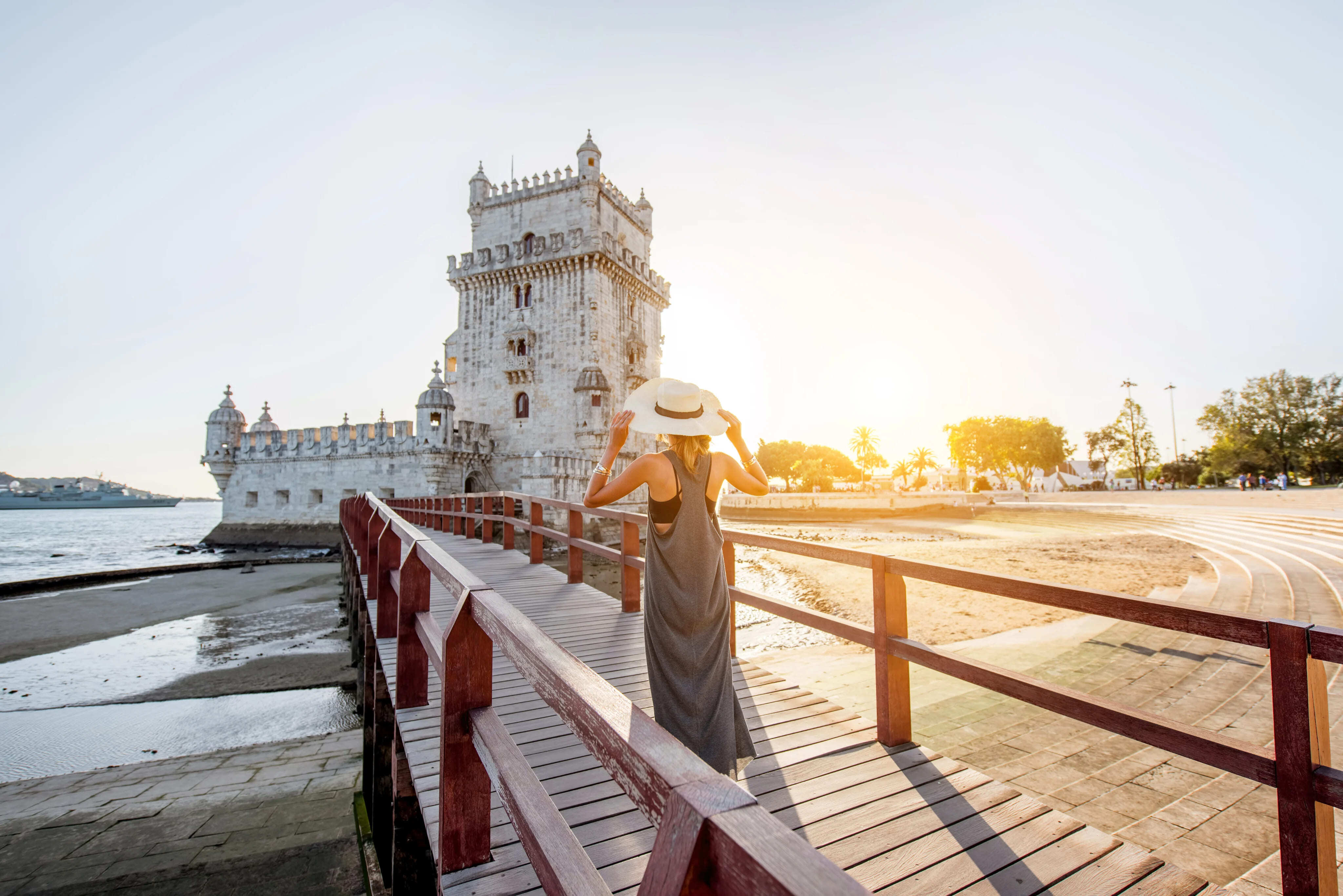Woman admiring Belém Tower in Lisbon, historic landmark associated with Golden Visa lifestyle