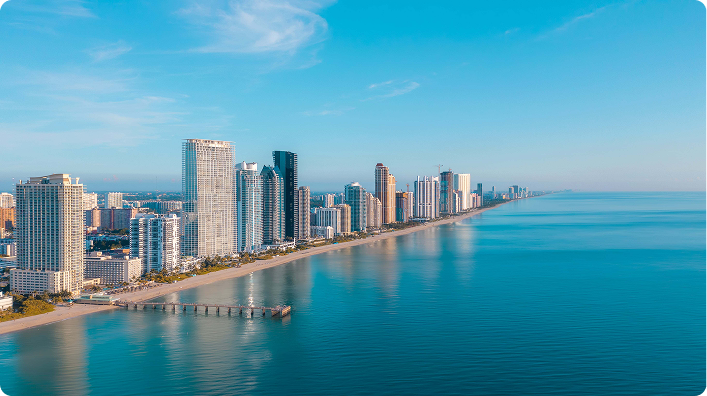 Aerial view of Miami coastline, Florida, with modern skyscrapers along the ocean.